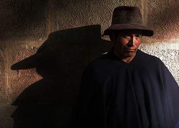 Seprian Choqui, 58, warms up in the early morning sun along the wall of the Government Palace in Sucre. 